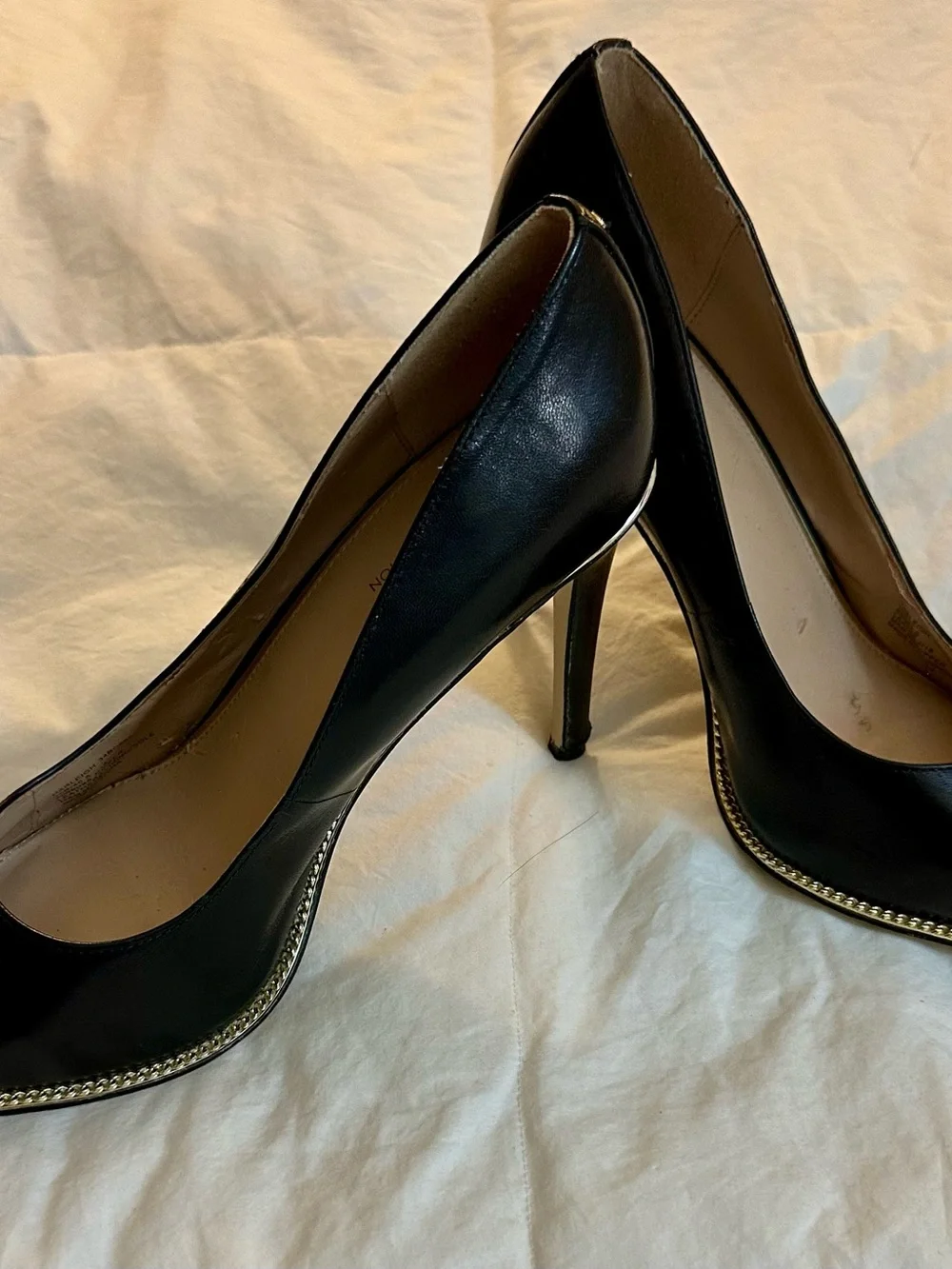 BCBGeneration Black Pointed Toe Pumps with Gold Trim